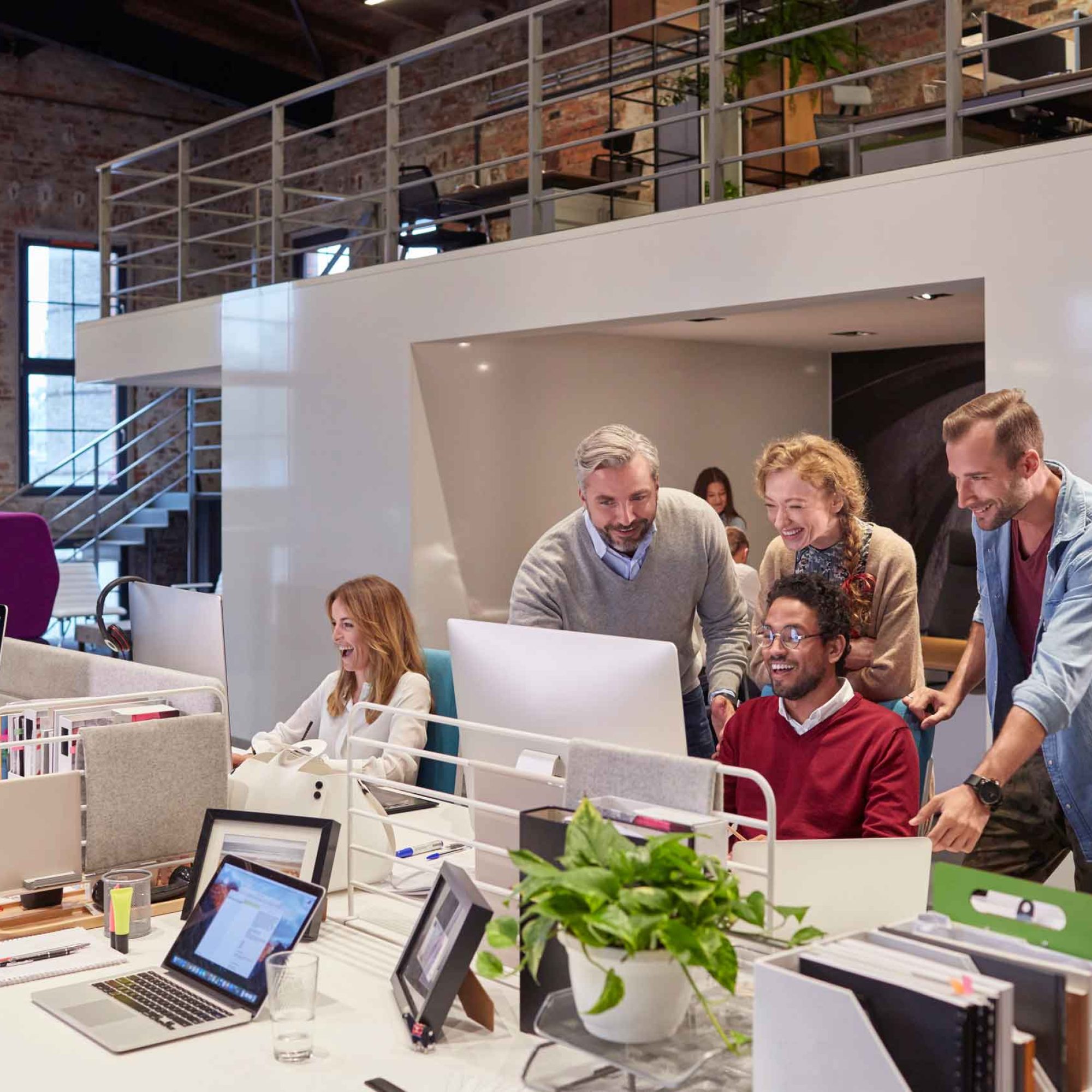 colleagues-looking-over-shoulder-of-young-man-work-2024-09-21-22-50-31-utc.jpg
